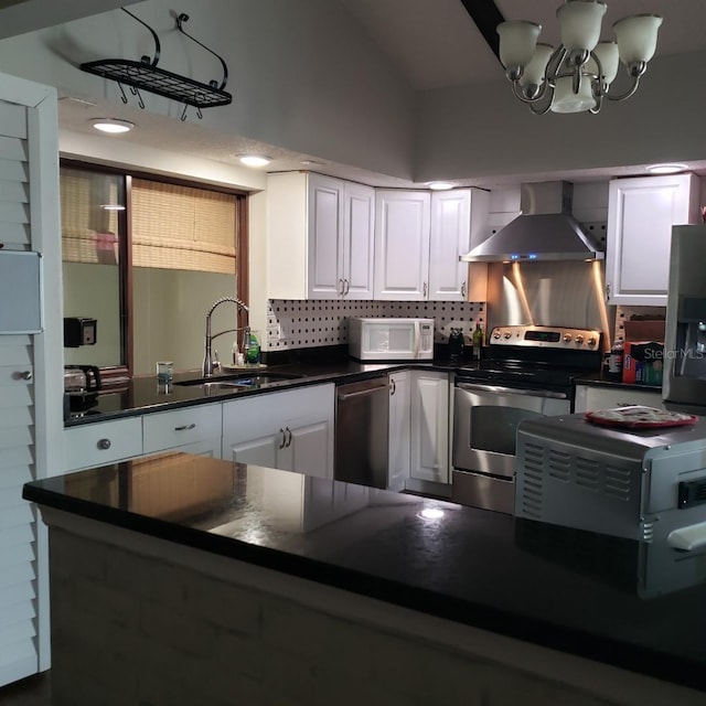 kitchen featuring a sink, dark countertops, wall chimney exhaust hood, white cabinetry, and appliances with stainless steel finishes