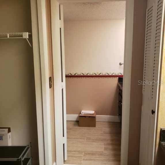 bathroom with baseboards and wood finished floors
