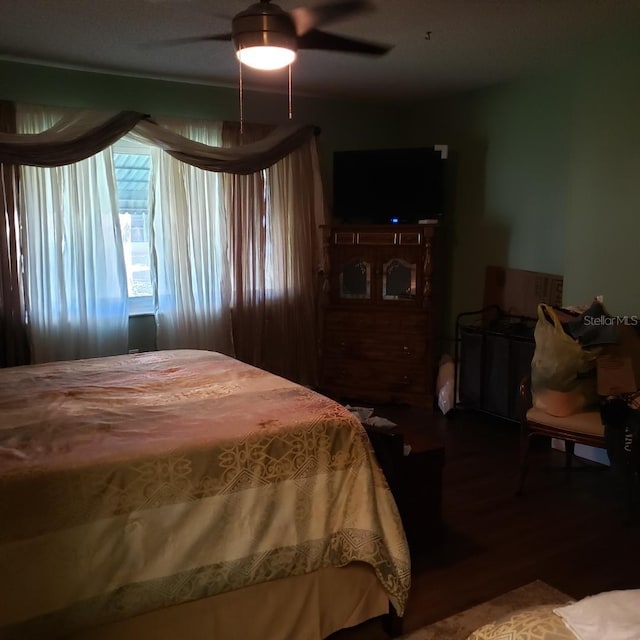 bedroom with a ceiling fan and wood finished floors