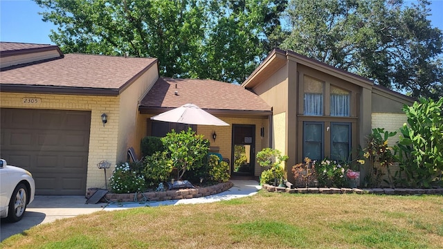 view of front of home featuring a front lawn, a shingled roof, brick siding, and an attached garage