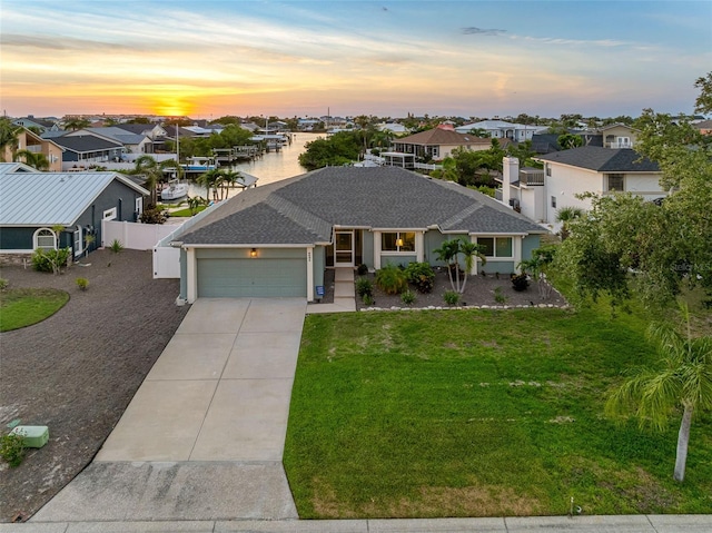 6604 Dolphin Cove Dr, Apollo Beach, FL 33572 - ranch-style house with an attached garage, driveway, a residential view, stucco siding, and roof with shingles