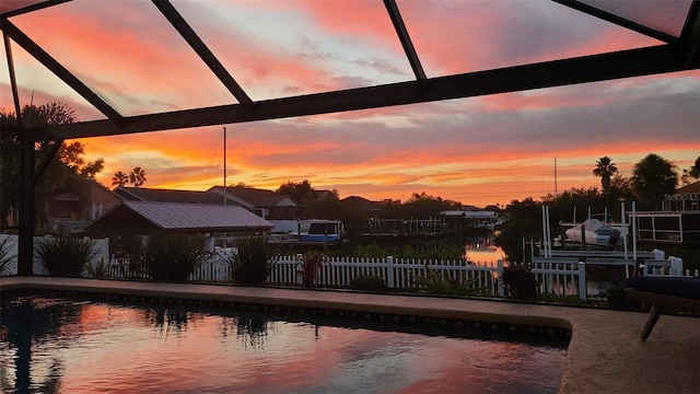 6604 Dolphin Cove Dr, Apollo Beach, FL 33572 - pool at dusk featuring a lanai, boat lift, and a dock