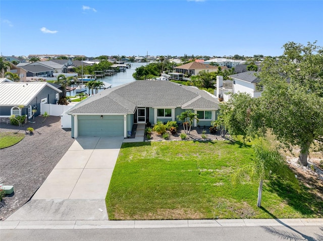 6604 Dolphin Cove Dr, Apollo Beach, FL 33572 - ranch-style home featuring a garage, concrete driveway, a residential view, and a water view