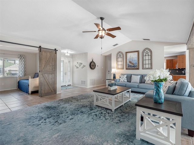 6604 Dolphin Cove Dr, Apollo Beach, FL 33572 - tiled living room with a barn door, a ceiling fan, baseboards, and vaulted ceiling