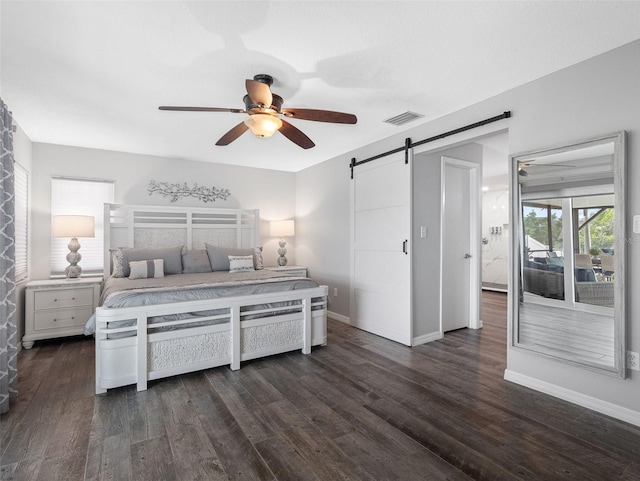 6604 Dolphin Cove Dr, Apollo Beach, FL 33572 - bedroom with a barn door, dark wood-type flooring, baseboards, and ceiling fan