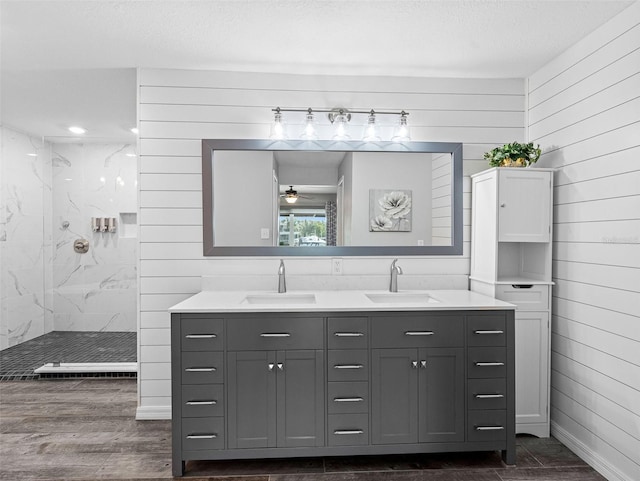 6604 Dolphin Cove Dr, Apollo Beach, FL 33572 - full bathroom with wood walls, a marble finish shower, double vanity, ceiling fan, and wood finished floors