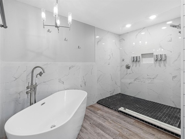 6604 Dolphin Cove Dr, Apollo Beach, FL 33572 - bathroom with a soaking tub, tile walls, a marble finish shower, wood finished floors, and recessed lighting