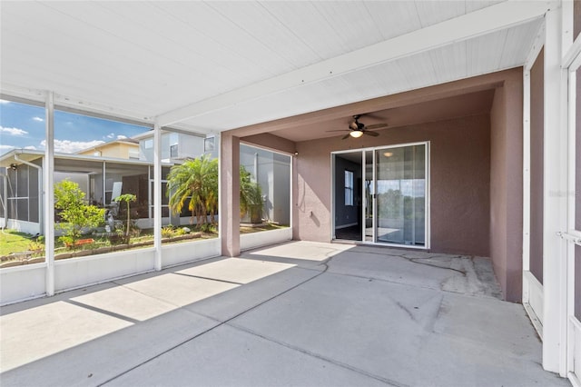 view of patio with ceiling fan and a sunroom