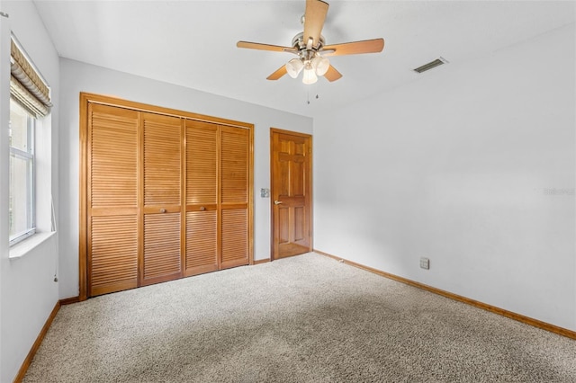 3001 Folklore Dr, Valrico, FL 33596 - unfurnished bedroom with carpet floors, a closet, and a ceiling fan