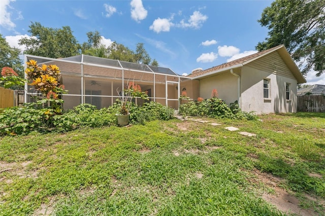 3001 Folklore Dr, Valrico, FL 33596 - rear view of property featuring stucco siding, a ceiling fan, and glass enclosure