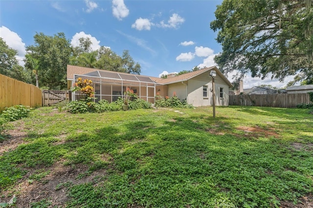 3001 Folklore Dr, Valrico, FL 33596 - back of house featuring a fenced backyard, stucco siding, and glass enclosure
