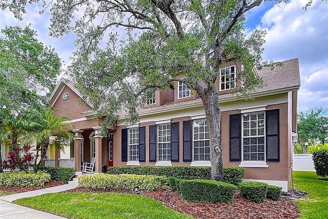 10309 Marchmont Ct, Tampa, FL 33626 - view of front of house featuring stucco siding, covered porch, and a front lawn