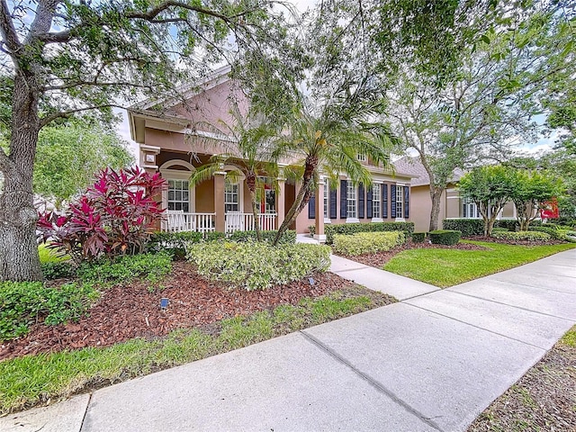 10309 Marchmont Ct, Tampa, FL 33626 - view of front of house featuring covered porch and stucco siding