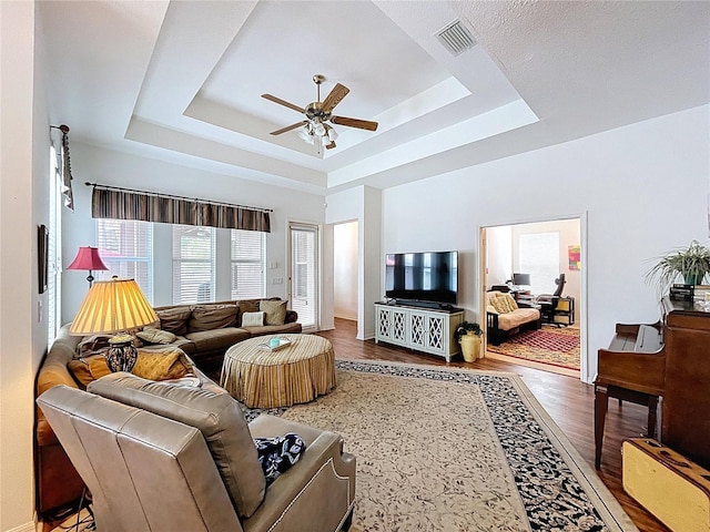 10309 Marchmont Ct, Tampa, FL 33626 - living room with ceiling fan, a raised ceiling, and wood finished floors