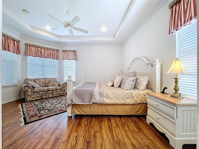 10309 Marchmont Ct, Tampa, FL 33626 - bedroom featuring a tray ceiling, dark wood-style flooring, ceiling fan, and recessed lighting