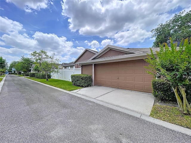 10309 Marchmont Ct, Tampa, FL 33626 - view of front facade with stucco siding, driveway, and an attached garage