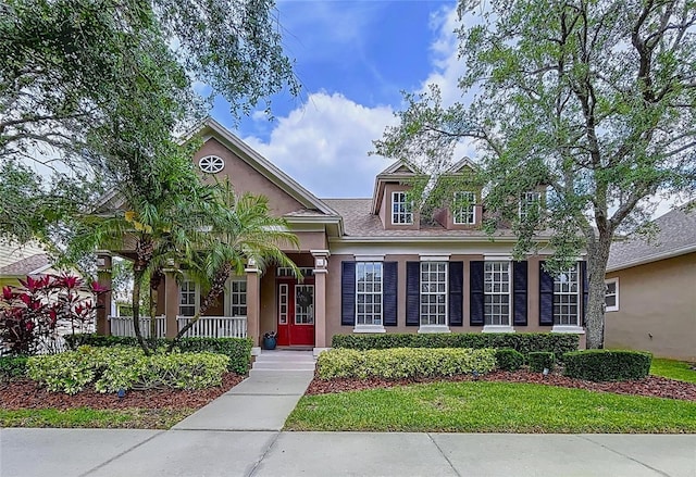 10309 Marchmont Ct, Tampa, FL 33626 - view of front facade featuring stucco siding and a porch