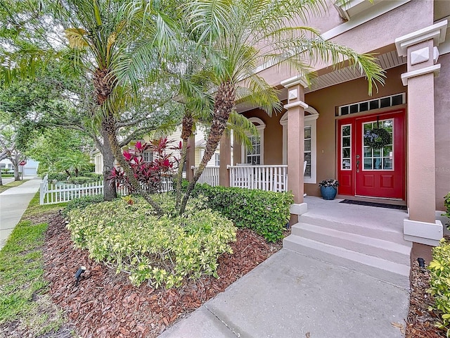 10309 Marchmont Ct, Tampa, FL 33626 - property entrance featuring stucco siding and a porch