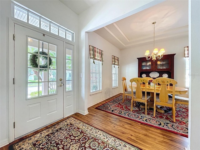 10309 Marchmont Ct, Tampa, FL 33626 - entryway featuring a chandelier, wood finished floors, and baseboards