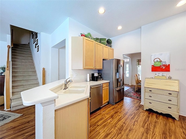 10309 Marchmont Ct, Tampa, FL 33626 - kitchen with stainless steel appliances, a sink, dark wood finished floors, light brown cabinetry, and a peninsula