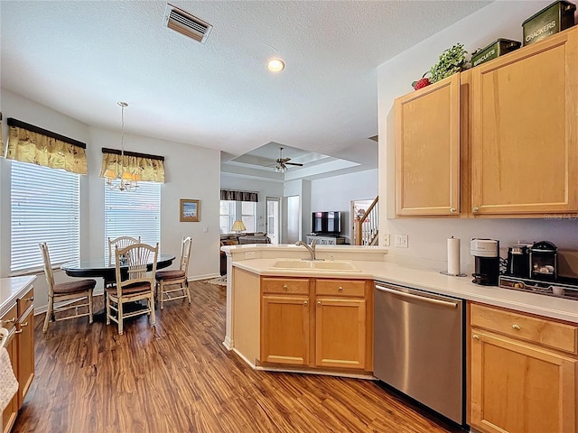 10309 Marchmont Ct, Tampa, FL 33626 - kitchen featuring stainless steel dishwasher, a sink, dark wood-style flooring, a textured ceiling, and a peninsula