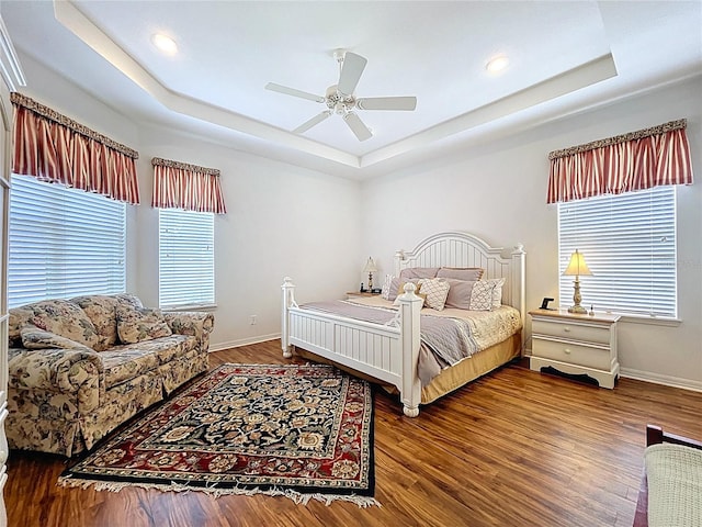 10309 Marchmont Ct, Tampa, FL 33626 - bedroom with a tray ceiling, baseboards, wood finished floors, a ceiling fan, and recessed lighting