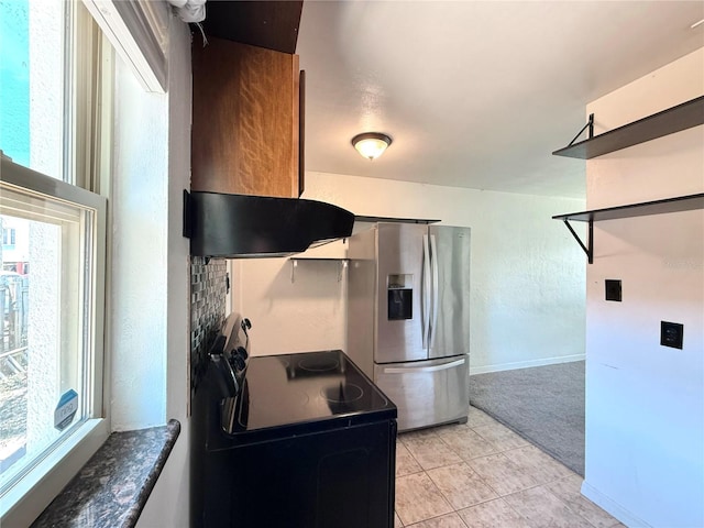 kitchen with light colored carpet, stainless steel refrigerator with ice dispenser, black electric range oven, and a healthy amount of sunlight