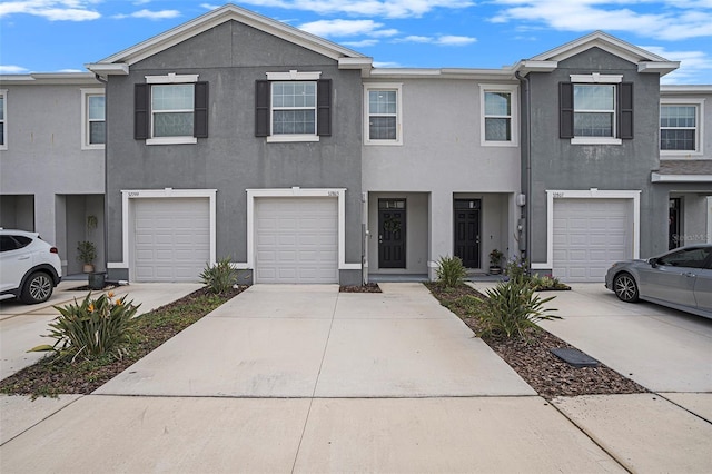 32803 Pez Landing Ln, Wesley Chapel, FL 33543 - multi unit property with stucco siding, driveway, and a garage