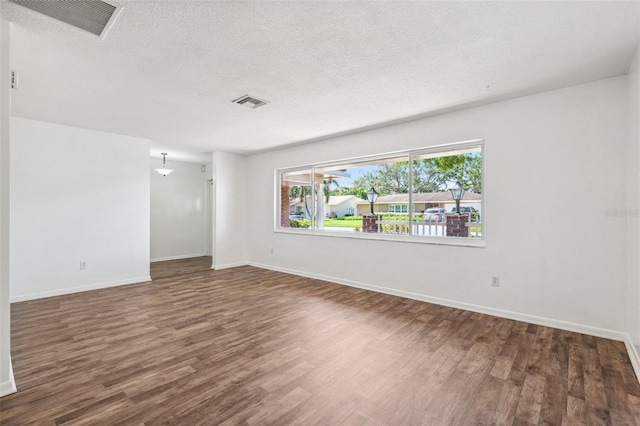 6365 32nd Ave N, Saint Petersburg, FL 33710 - unfurnished room featuring wood finished floors, a textured ceiling, and baseboards