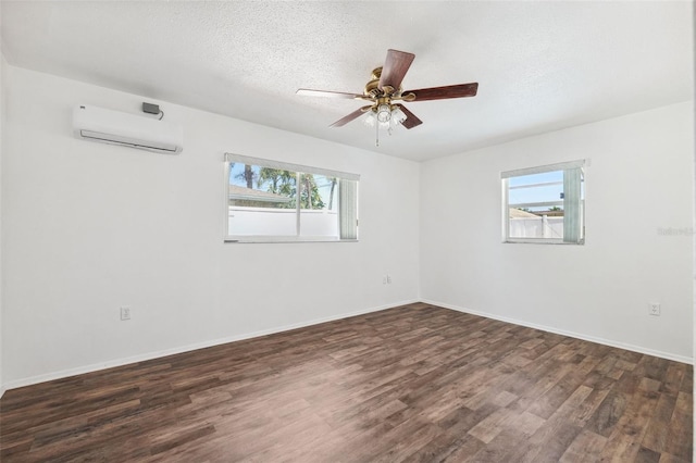 6365 32nd Ave N, Saint Petersburg, FL 33710 - unfurnished room featuring a wall mounted AC, healthy amount of natural light, dark wood-style floors, and a textured ceiling