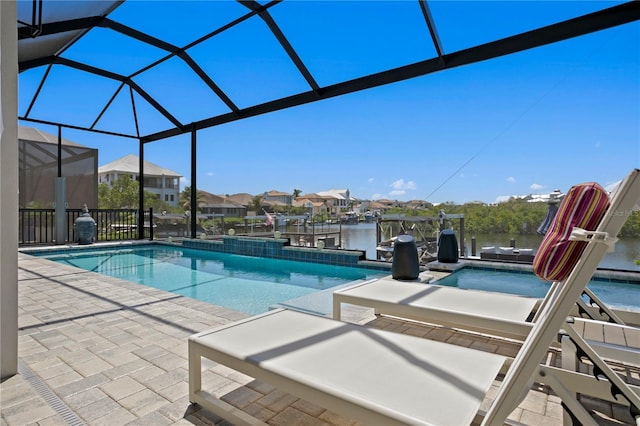 pool featuring a patio, a water view, glass enclosure, and a dock