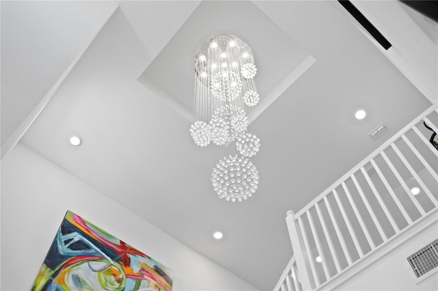 details featuring visible vents, recessed lighting, and a notable chandelier