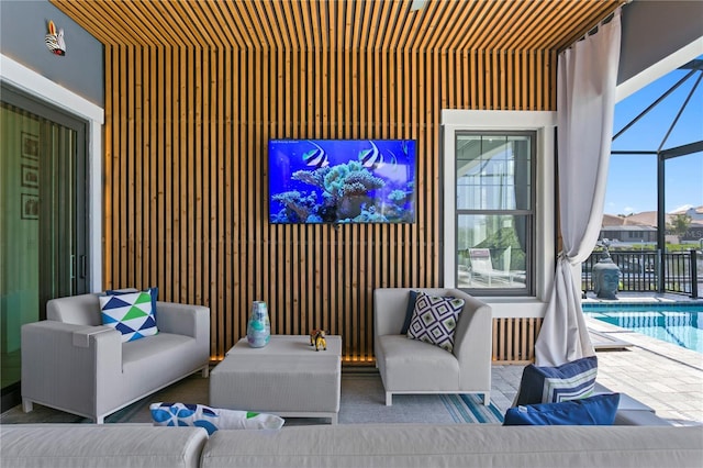 view of patio with a fenced in pool, glass enclosure, and outdoor lounge area