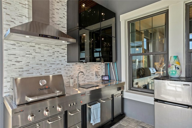 kitchen with tasteful backsplash and wall chimney exhaust hood