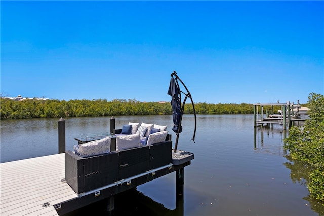 view of dock with boat lift and a water view