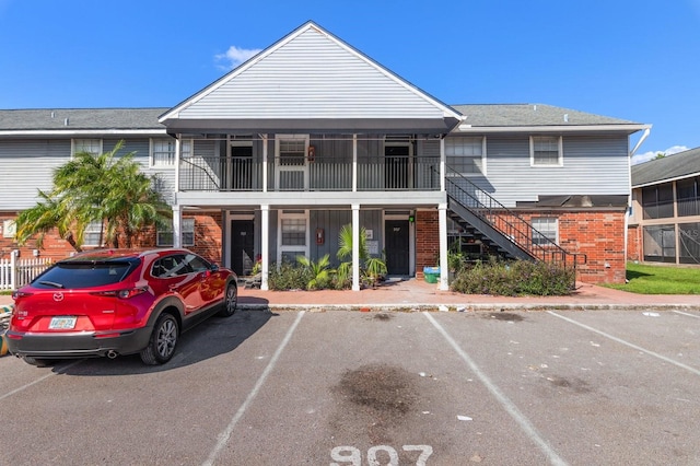 200 Country Club Dr Unit 906, Largo, FL 33771 - view of building exterior featuring uncovered parking and stairway