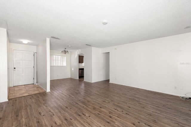 200 Country Club Dr Unit 906, Largo, FL 33771 - unfurnished living room featuring an inviting chandelier, baseboards, wood finished floors, and visible vents