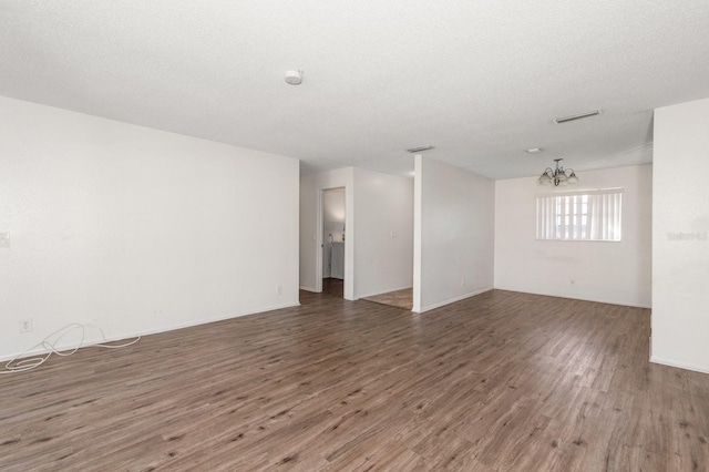 200 Country Club Dr Unit 906, Largo, FL 33771 - unfurnished room with an inviting chandelier, wood finished floors, and visible vents