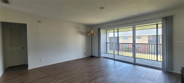 200 Country Club Dr Unit 906, Largo, FL 33771 - empty room with a textured ceiling, visible vents, baseboards, and dark wood-type flooring
