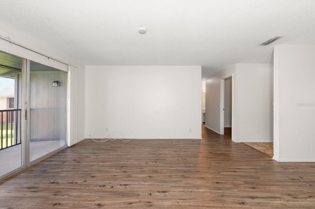 200 Country Club Dr Unit 906, Largo, FL 33771 - spare room featuring baseboards, wood finished floors, and visible vents