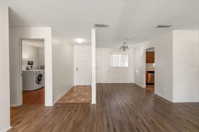 200 Country Club Dr Unit 906, Largo, FL 33771 - interior space featuring visible vents, dark wood-style flooring, independent washer and dryer, and an inviting chandelier
