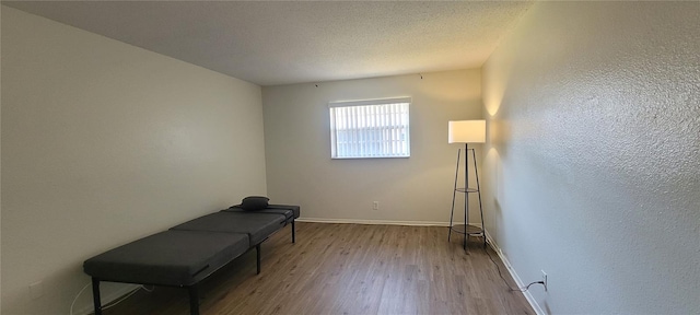 200 Country Club Dr Unit 906, Largo, FL 33771 - unfurnished room featuring baseboards, a textured ceiling, and wood finished floors