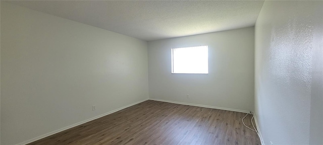 200 Country Club Dr Unit 906, Largo, FL 33771 - unfurnished room featuring baseboards and dark wood-style flooring