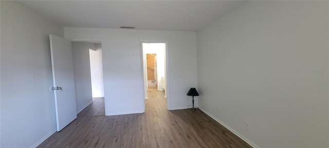 200 Country Club Dr Unit 906, Largo, FL 33771 - unfurnished room featuring baseboards, wood finished floors, and visible vents