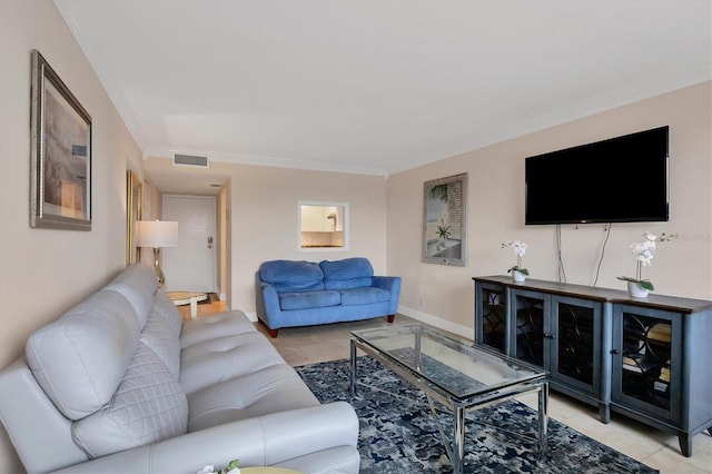 living area with baseboards, visible vents, and ornamental molding