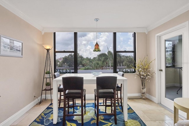 dining area with baseboards, ornamental molding, light tile patterned flooring, and a wealth of natural light