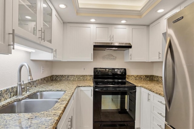 kitchen featuring freestanding refrigerator, electric range, white cabinetry, under cabinet range hood, and a sink