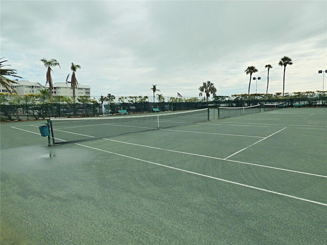 view of tennis court featuring fence