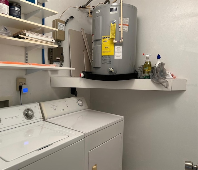 clothes washing area with washing machine and clothes dryer and electric water heater