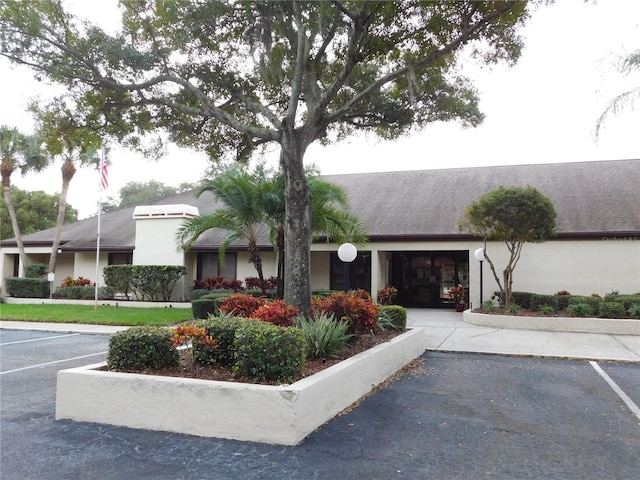 view of property featuring uncovered parking